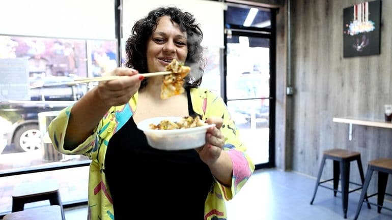 Newsday food writer Andi Berlin tries dumplings at White Bear in Great Neck on Monday, Oct. 27, 2025.