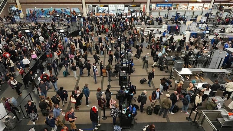 Travelers wade through the south security checkpoint in Denver International Airport Thursday, Dec. 19, 2024, in Denver.